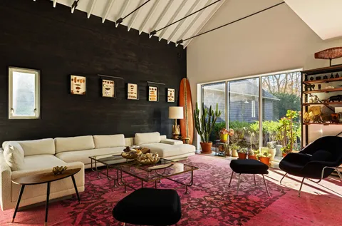 a living room with furniture and a floor to ceiling window