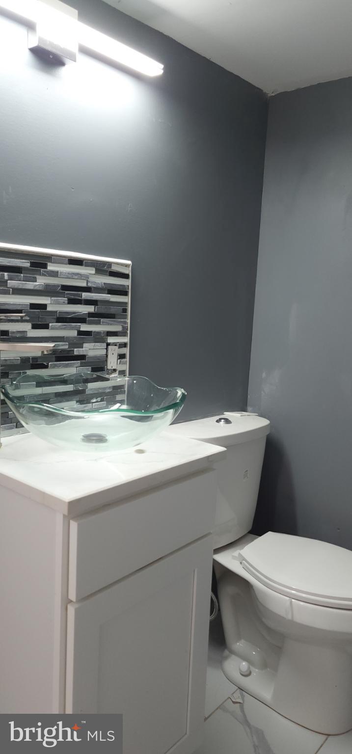 29 Concord Road Darby, PA 19023 - Photo 20 of 21 a bathroom with a granite countertop toilet and a sink