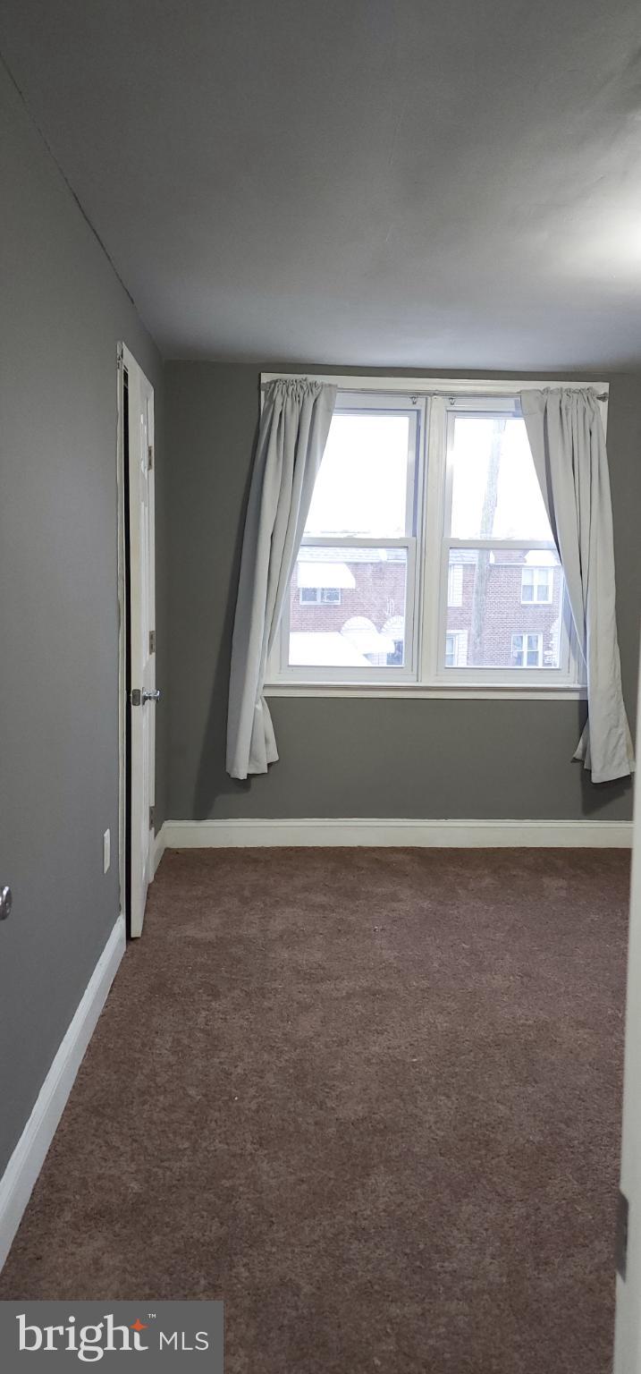 29 Concord Road Darby, PA 19023 - Photo 8 of 21 an empty room with wooden floor and windows