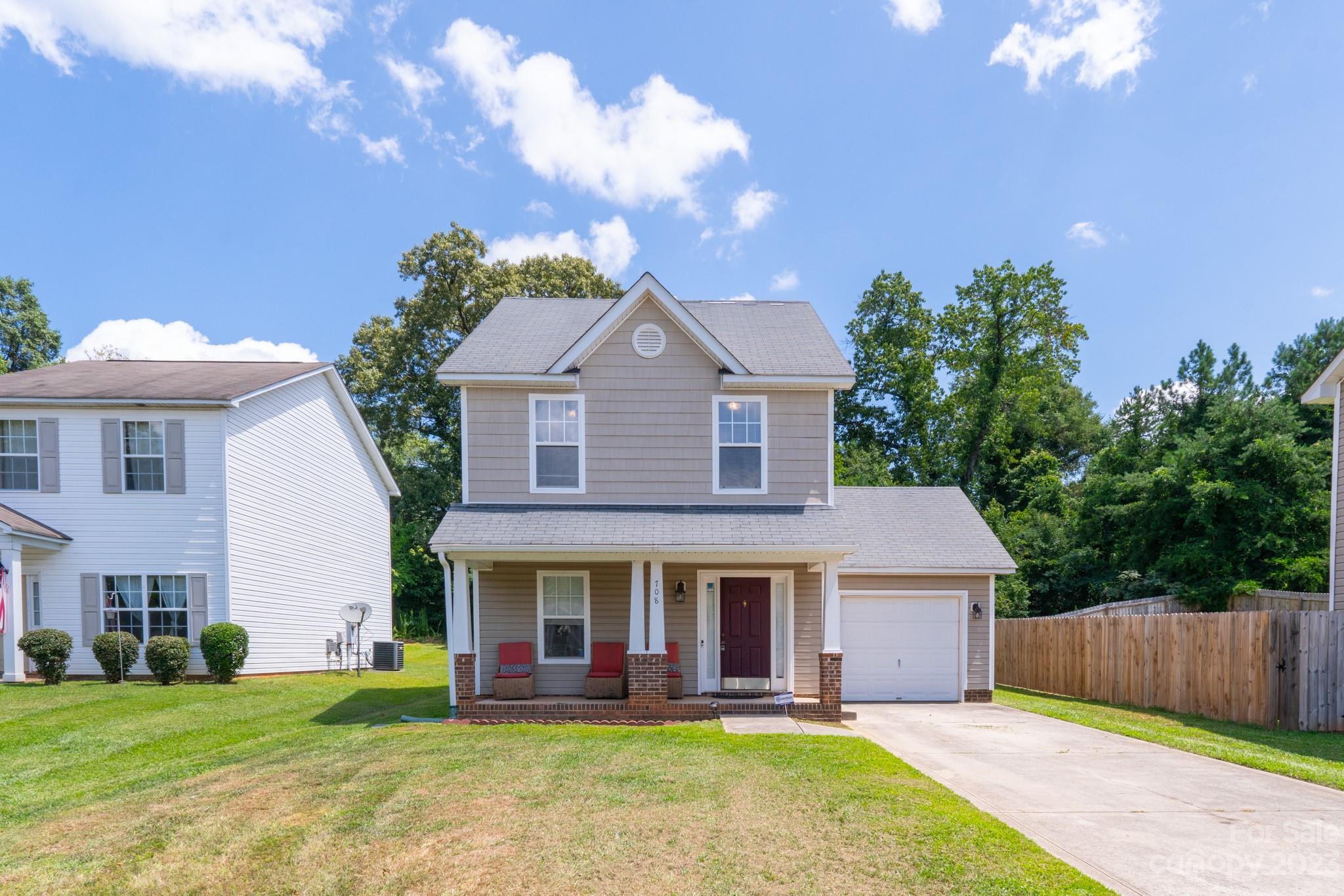 a front view of a house with a garden and plants