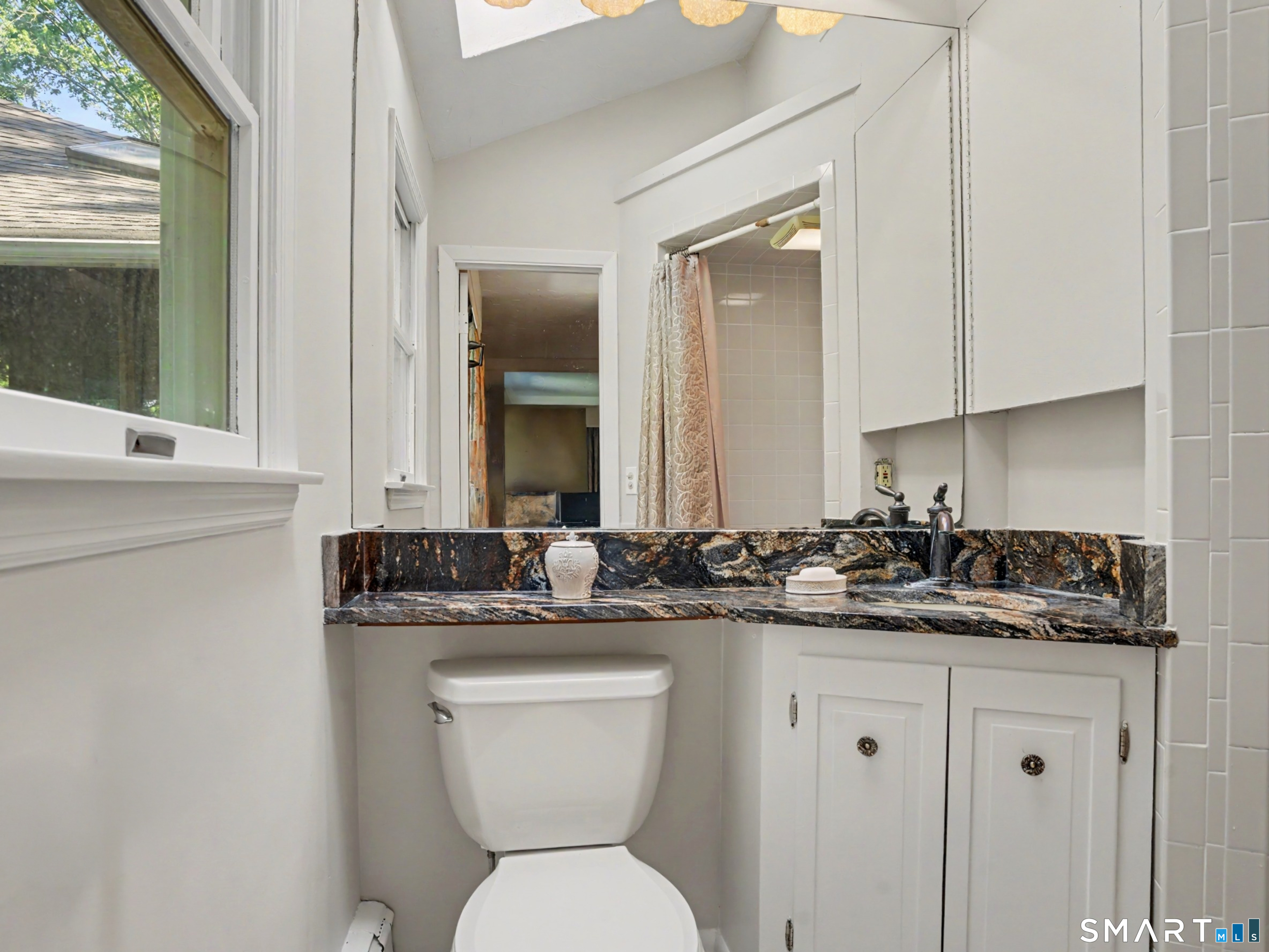 15 Flat Rock Drive Ridgefield, CT 06877 - Photo 26 of 39 a bathroom with a granite countertop toilet sink and mirror