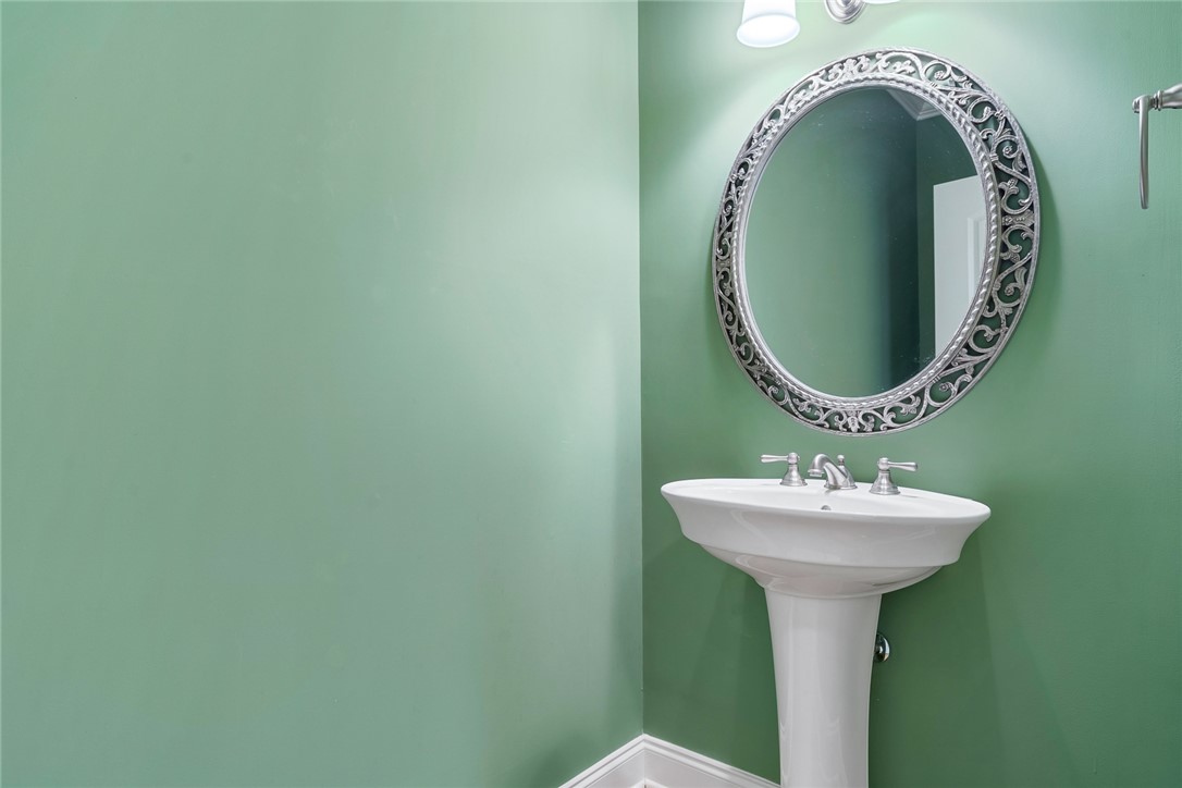 16 Oleander Drive Anderson, SC 29621 - Photo 20 of 37 A graceful pedestal sink and ornate mirror complete this well-appointed powder room.