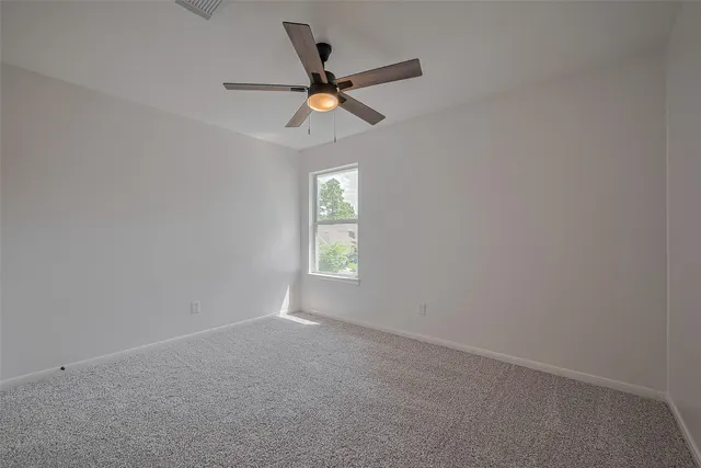 a view of room with window and ceiling fan