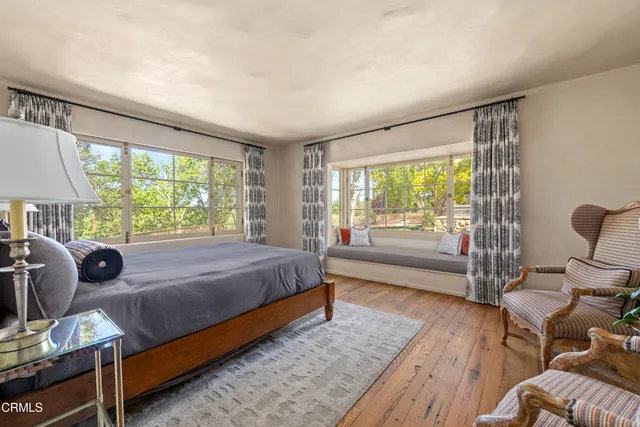 a view of backyard with a barn and large trees
