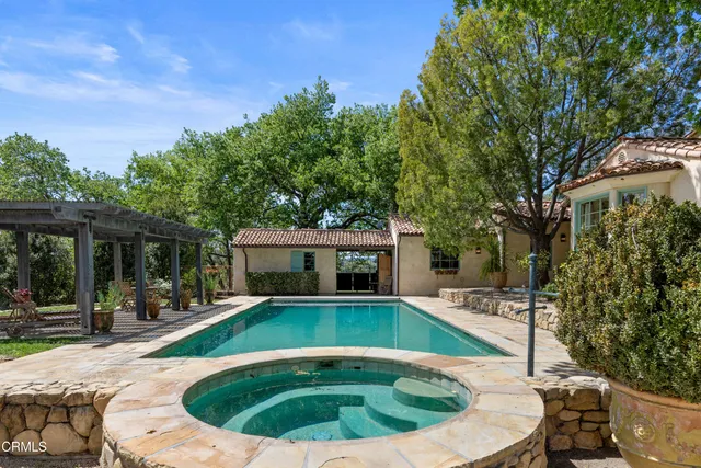 a view of a chair and table in backyard of the house