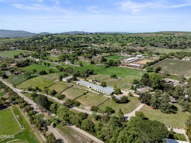 an aerial view of a city with lots of residential buildings and mountain view in back
