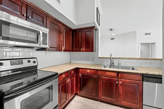 a view of a kitchen with wooden floor and a refrigerator