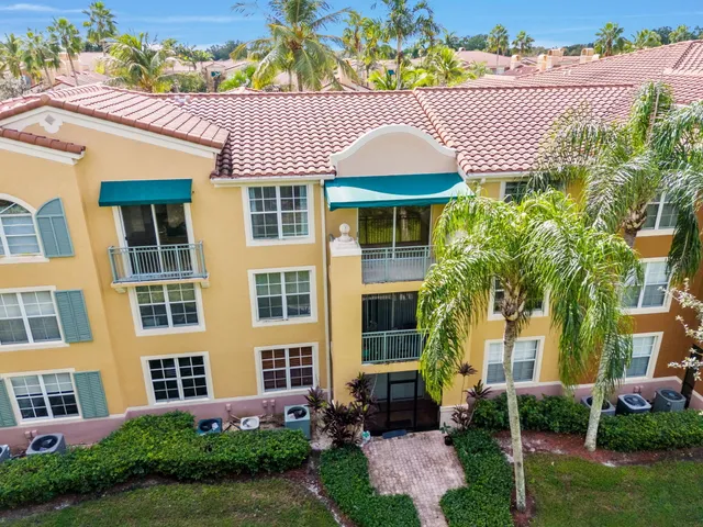 front view of a building with a garden and plants