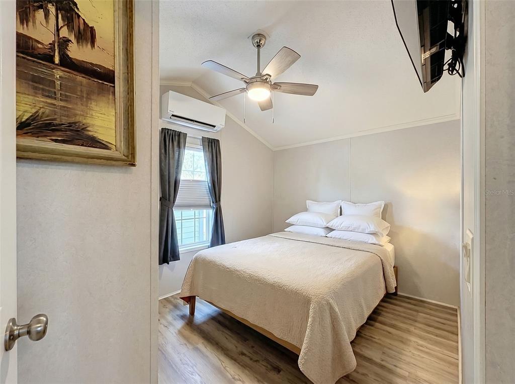 2092 Culbreath Road, Unit A42 Brooksville, FL 34602 - Photo 64 of 70 a bedroom with a bed and a mirror
