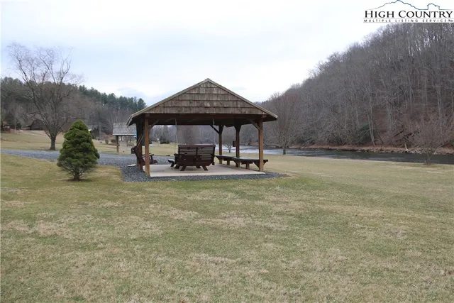 a view of patio with a table and chairs under an umbrella