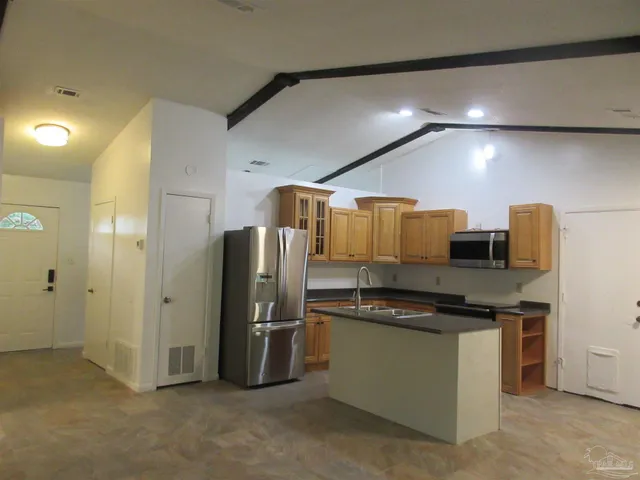 a kitchen with stainless steel appliances a refrigerator and a stove
