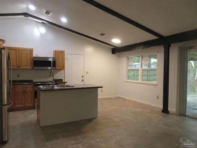 a kitchen with stainless steel appliances granite countertop a sink and a stove