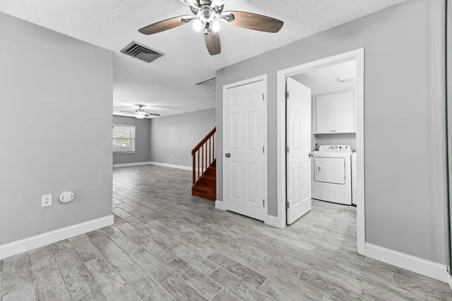 wooden floor in an empty room with a bathroom