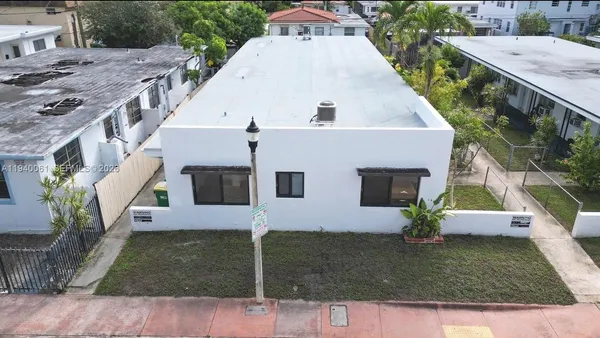 a aerial view of a house with a yard