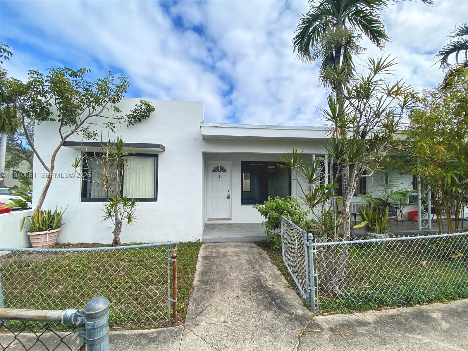 650 83rd Street, Unit 3 Miami Beach, FL 33141 - Photo 3 of 23 a front view of a house with a yard