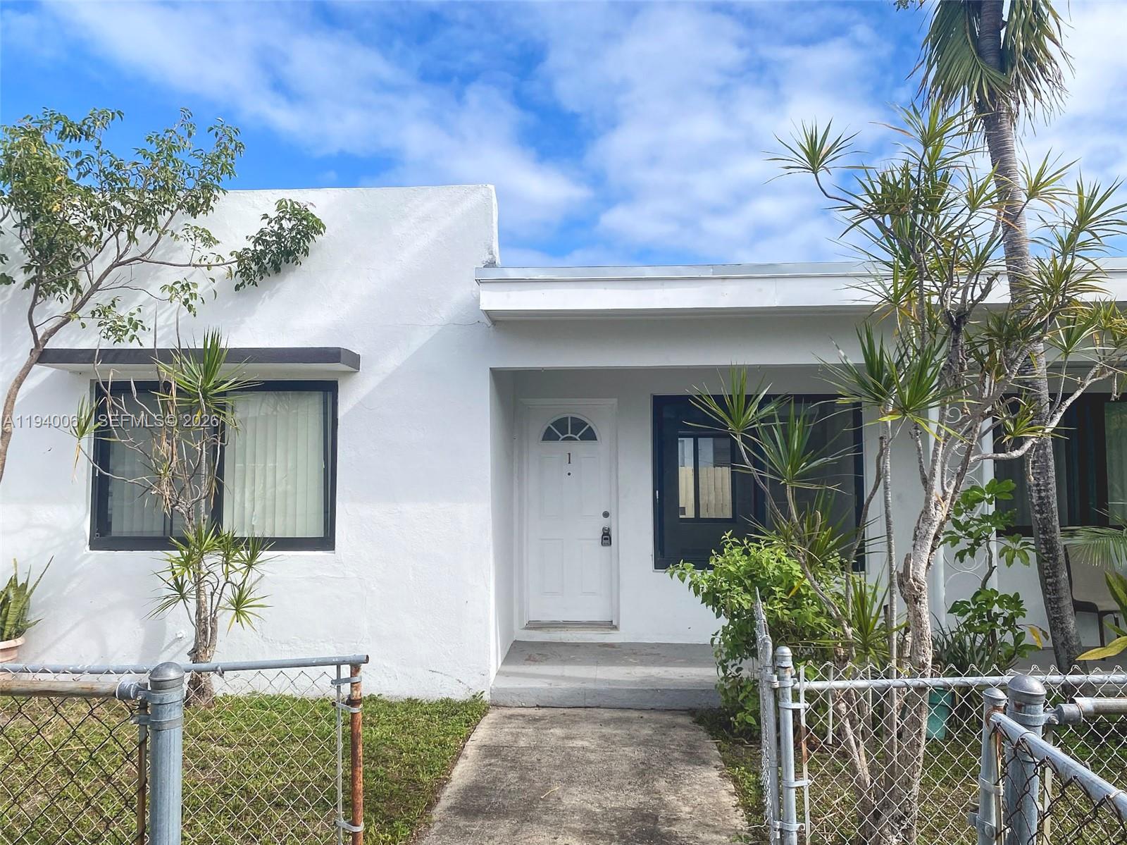650 83rd Street, Unit 3 Miami Beach, FL 33141 - Photo 4 of 23 a front view of a house with a porch