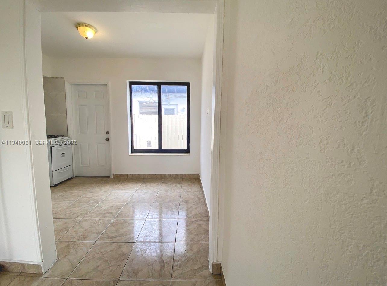 650 83rd Street, Unit 3 Miami Beach, FL 33141 - Photo 6 of 23 an empty room with windows