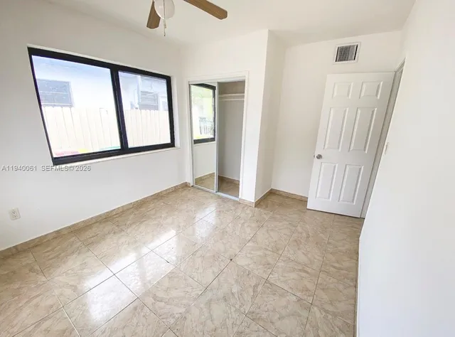 a view of an empty room with windows