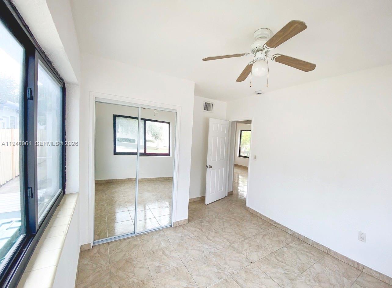 650 83rd Street, Unit 3 Miami Beach, FL 33141 - Photo 10 of 23 an empty room with windows and fan