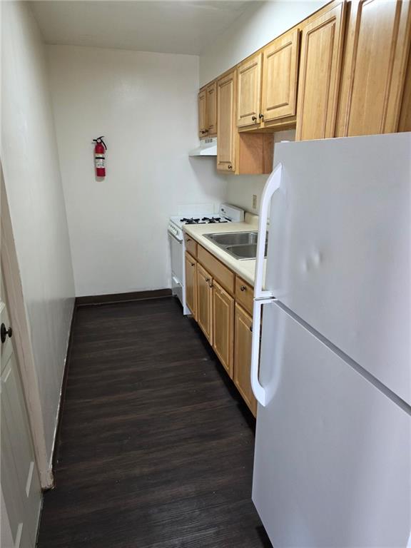300 Helen Street McKees Rocks, PA 15136 - Photo 25 of 48 a kitchen with a refrigerator a stove top oven and wooden floor