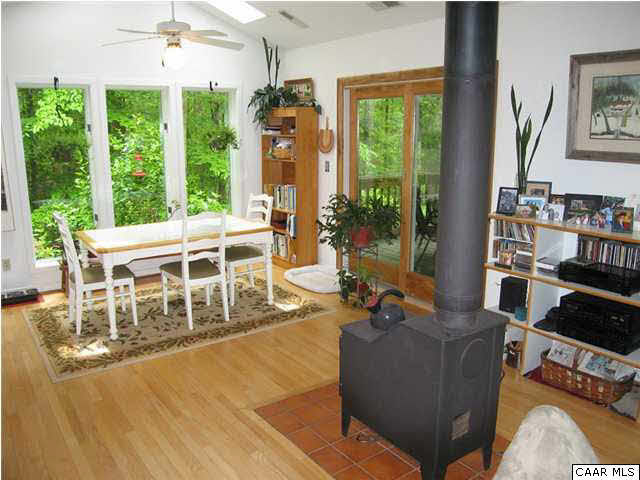 2864 Heartwood Road Afton, VA 22920 - Photo 7 of 21 a living room with furniture potted plant floor to ceiling window and a flat screen tv