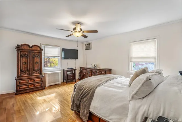 a view of a bedroom with furniture and flat screen tv