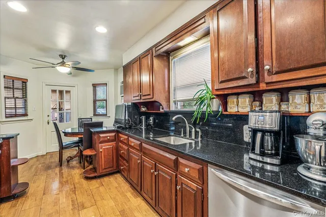 a kitchen with stainless steel appliances granite countertop sink stove and cabinets