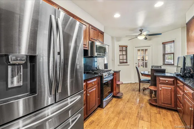 a kitchen with stainless steel appliances granite countertop a refrigerator stove and sink