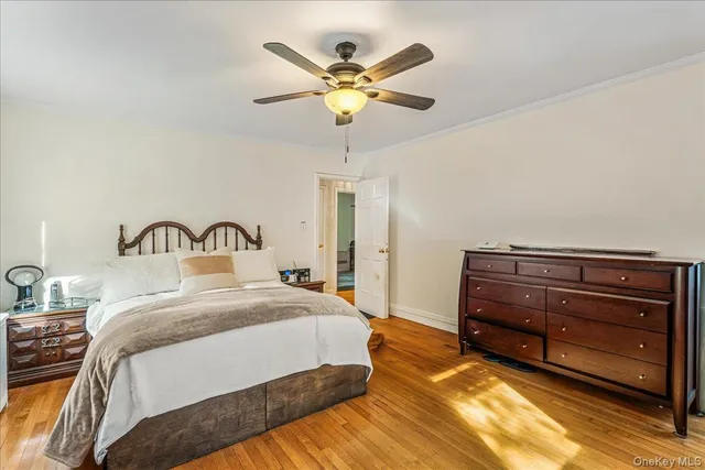 a bedroom with a bed and ceiling fan
