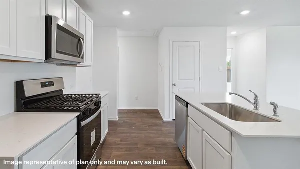 a kitchen that has a sink and a stove