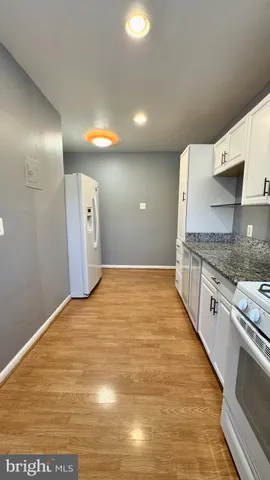 a view of a kitchen with a sink and cabinets