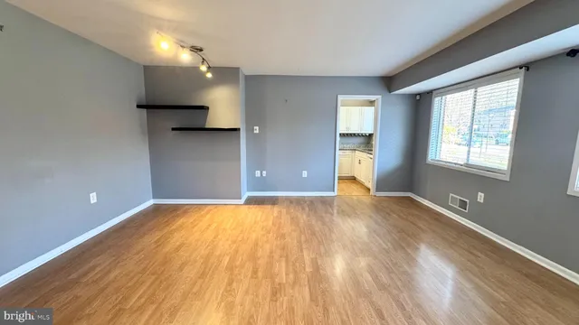 wooden floor in an empty room with a window