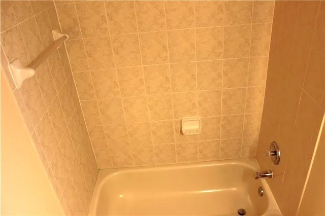 a room that has a window and dresser