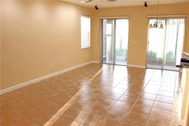 a view of a livingroom with an empty space and a window