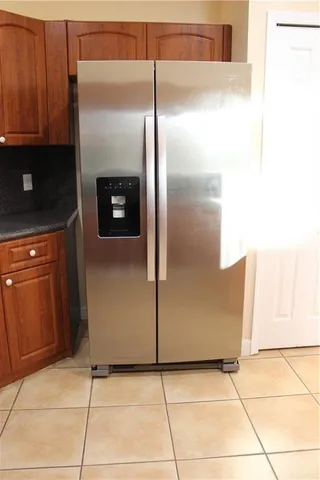a kitchen with metallic refrigerator freezer and a dishwasher