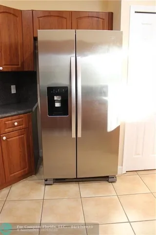 a kitchen with metallic refrigerator freezer and a dishwasher