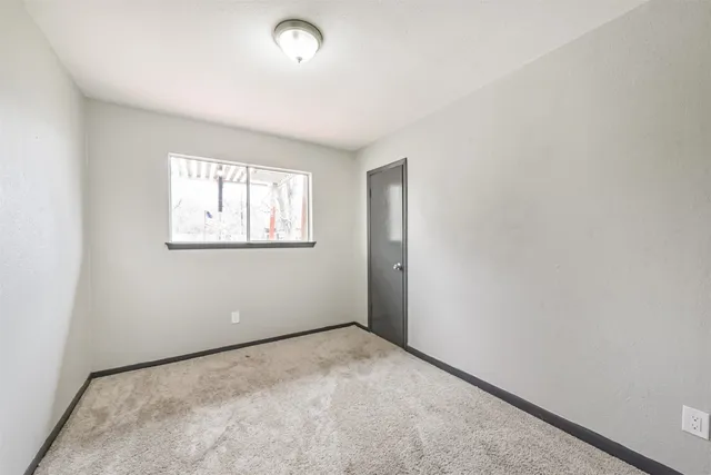 a view of a big room with wooden floor and a ceiling fan