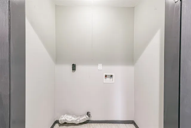 a view of a room with a barbeque and wooden floor