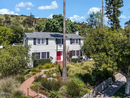 a view of house with yard
