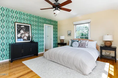 a bedroom with a bed and a painting on the wall
