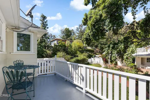 a view of a chair and tables front of the house