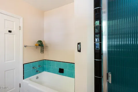 a bathroom with a bathtub and shower