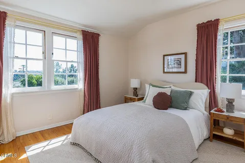 a bedroom with a large bed and a window