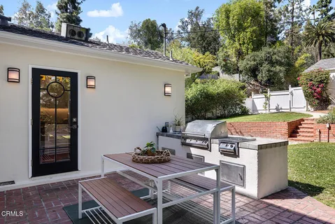 a view of a patio with table and chairs with wooden floor and fence
