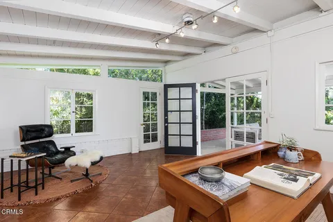 a living room with furniture and large window