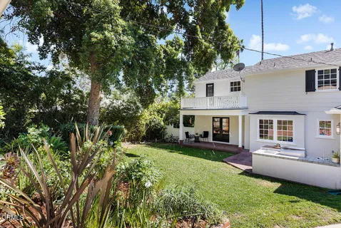 a aerial view of a house with swimming pool next to a yard