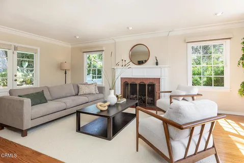 a living room with furniture fireplace and window