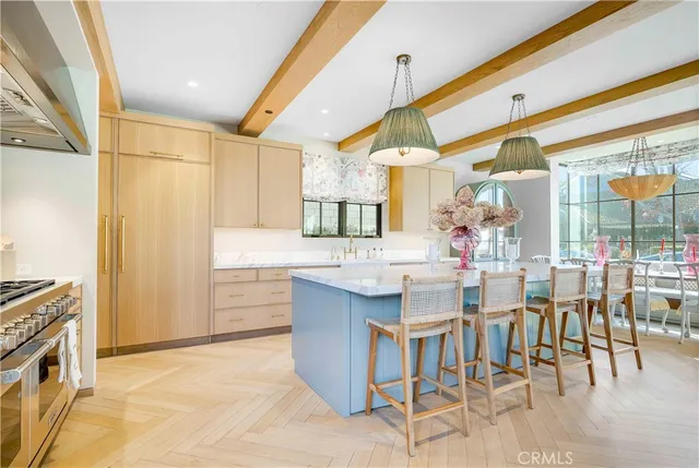 a kitchen with cabinets and chairs