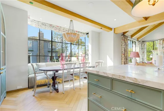 a dining room with furniture and a floor to ceiling window