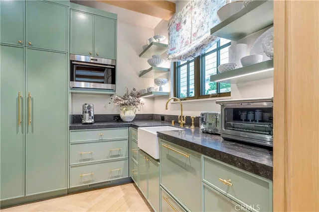 a kitchen with stainless steel appliances granite countertop a sink and cabinets
